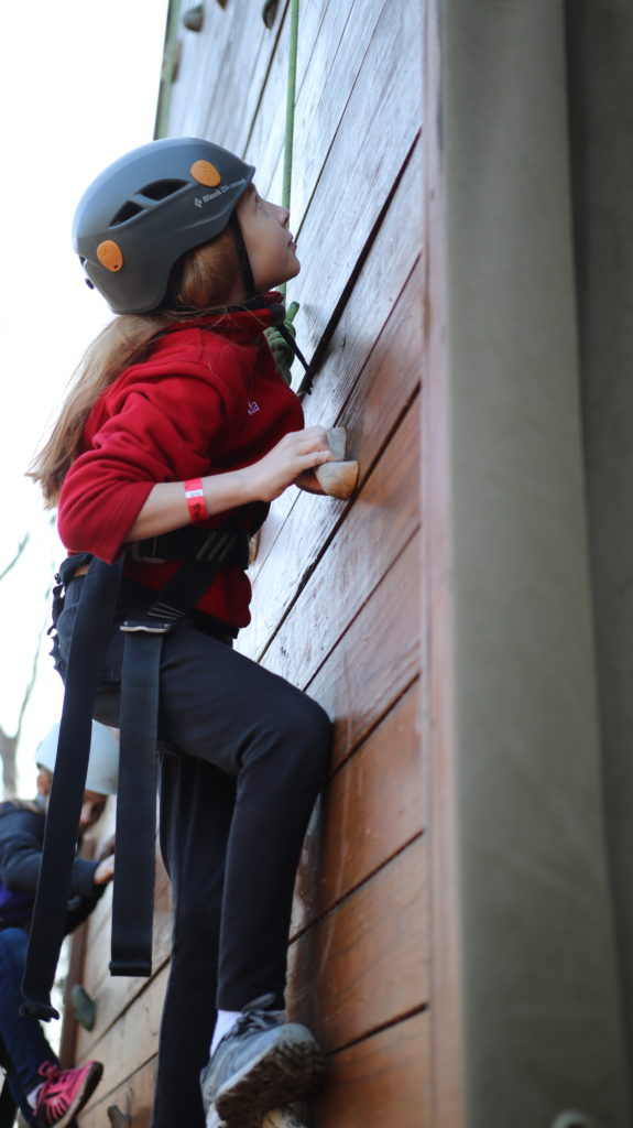 girl climbing wall